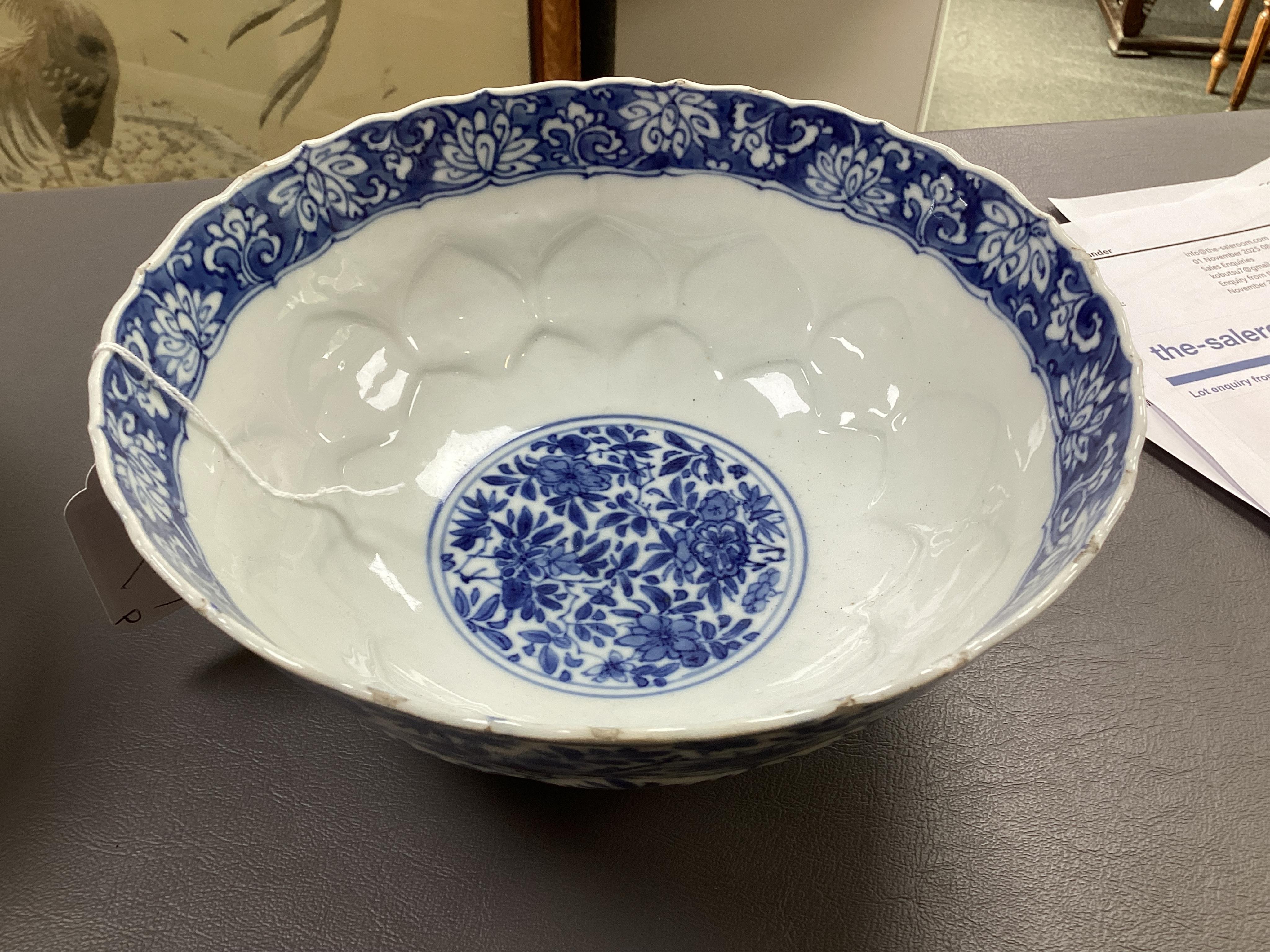 A near pair of Chinese blue and white lotus flower moulded bowls, Kangxi period